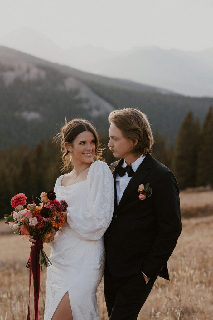 Bride and groom posing in the Colorado mountains for their elopement photos