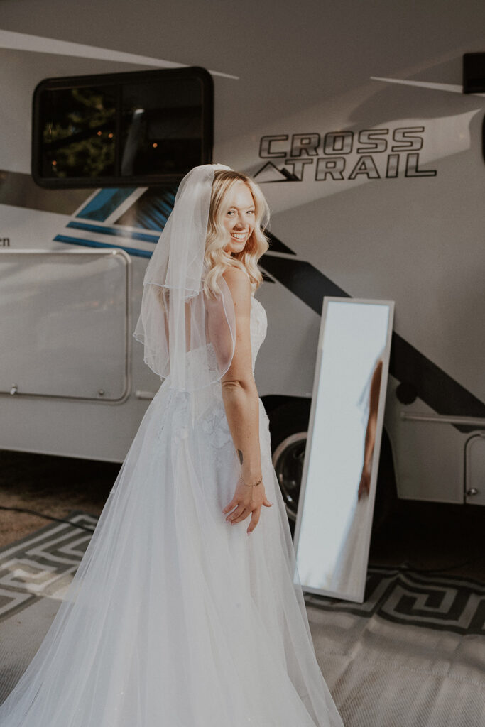 Bride looking at herself in a mirror after getting ready