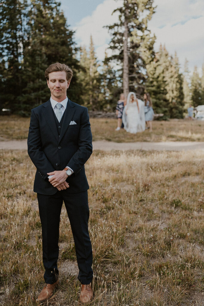 Bride walking towards her groom before sharing a first look