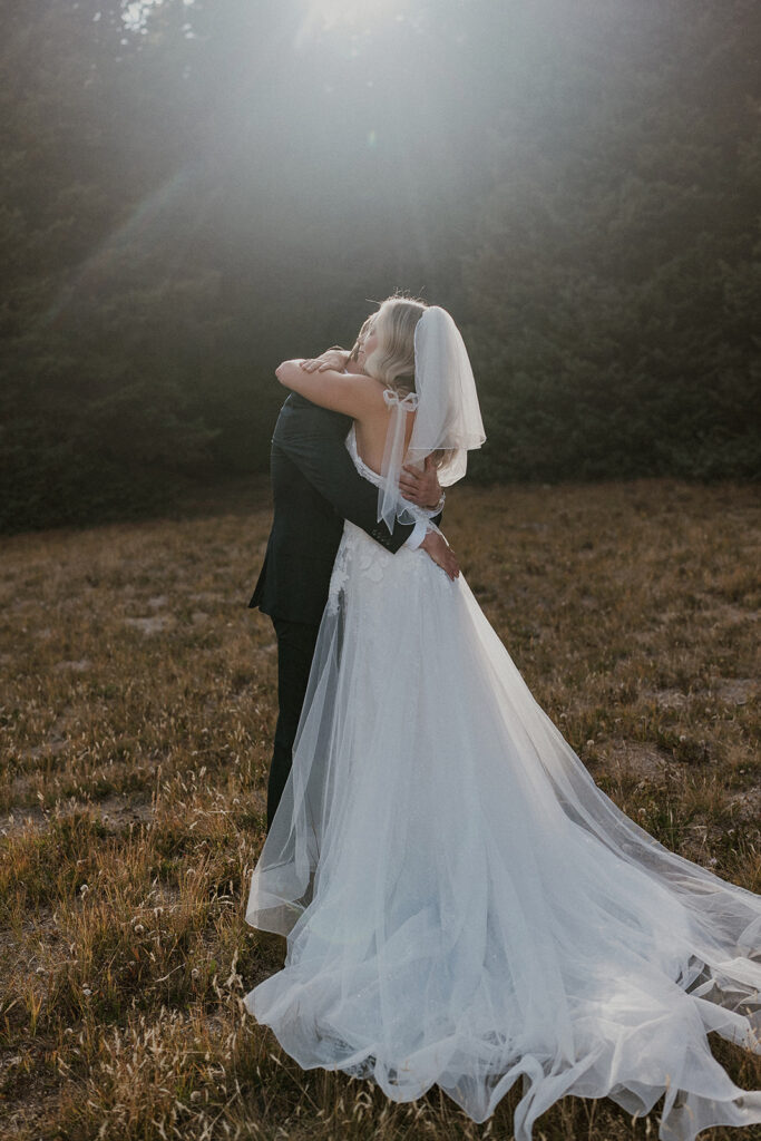 Bride and groom hugging after their first look