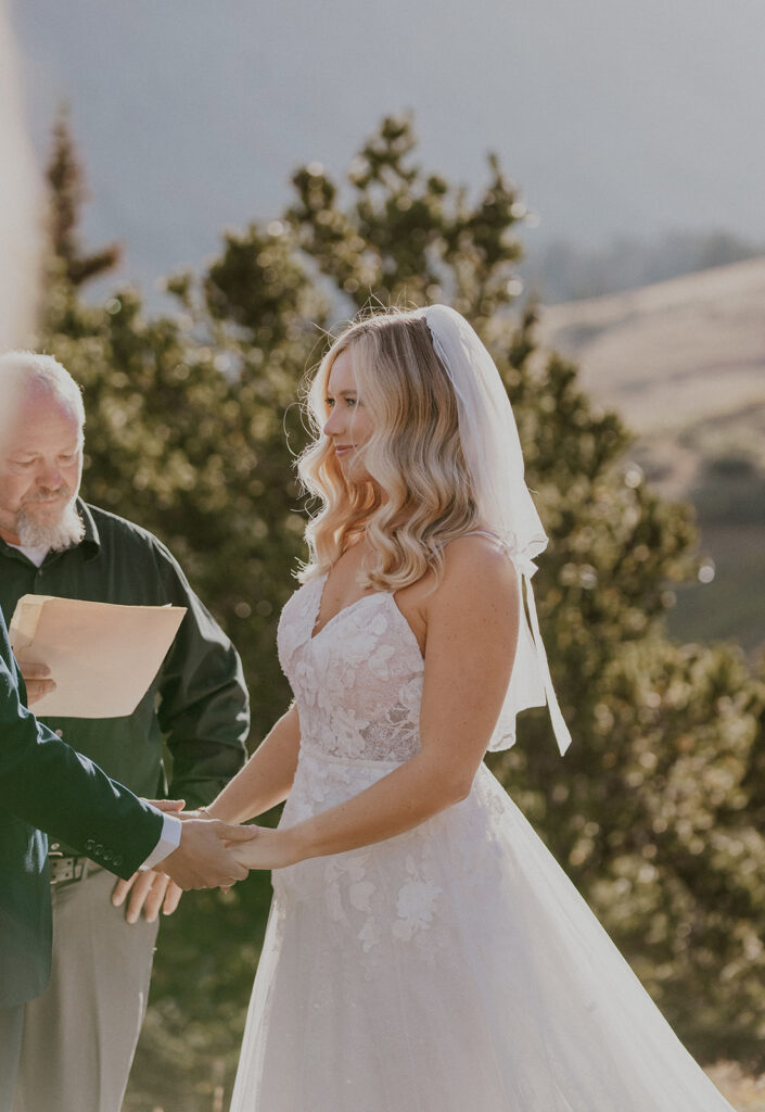 Bride and groom holding hands during their intimate Breckenridge wedding ceremony at Hoosier Pass