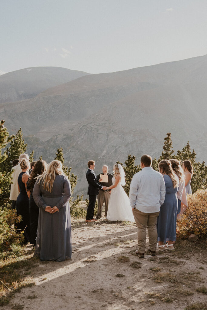 Bride and groom holding hands during their intimate Breckenridge wedding ceremony at Hoosier Pass