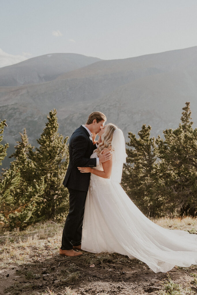 Bride and groom kissing during their intimate Breckenridge wedding ceremony at Hoosier Pass