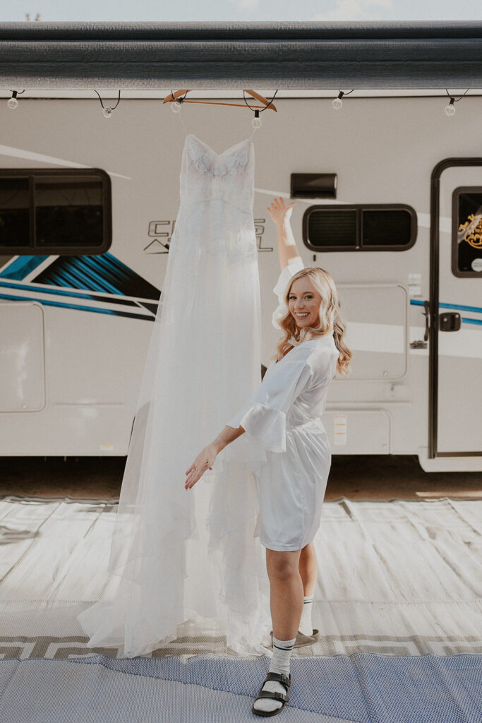 Bride posing with her wedding dress