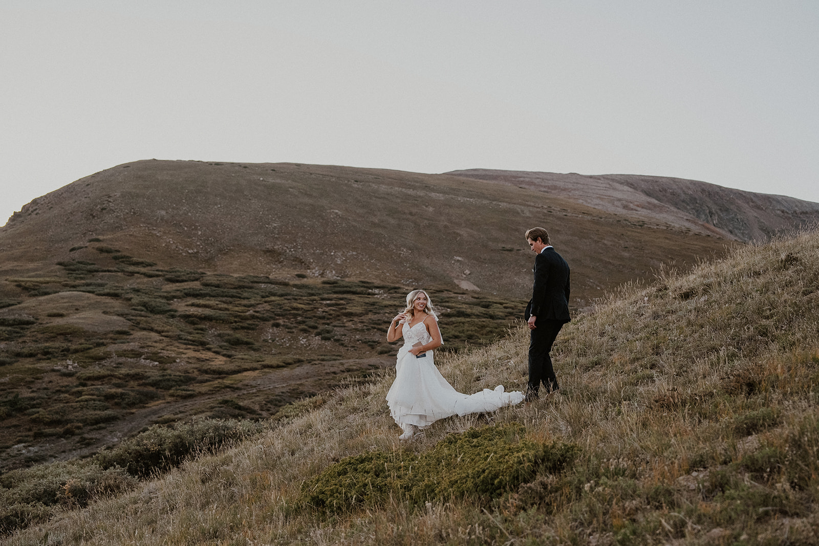 Bride and groom walking in the Colorado mountains for their intimate Breckenridge wedding portraits