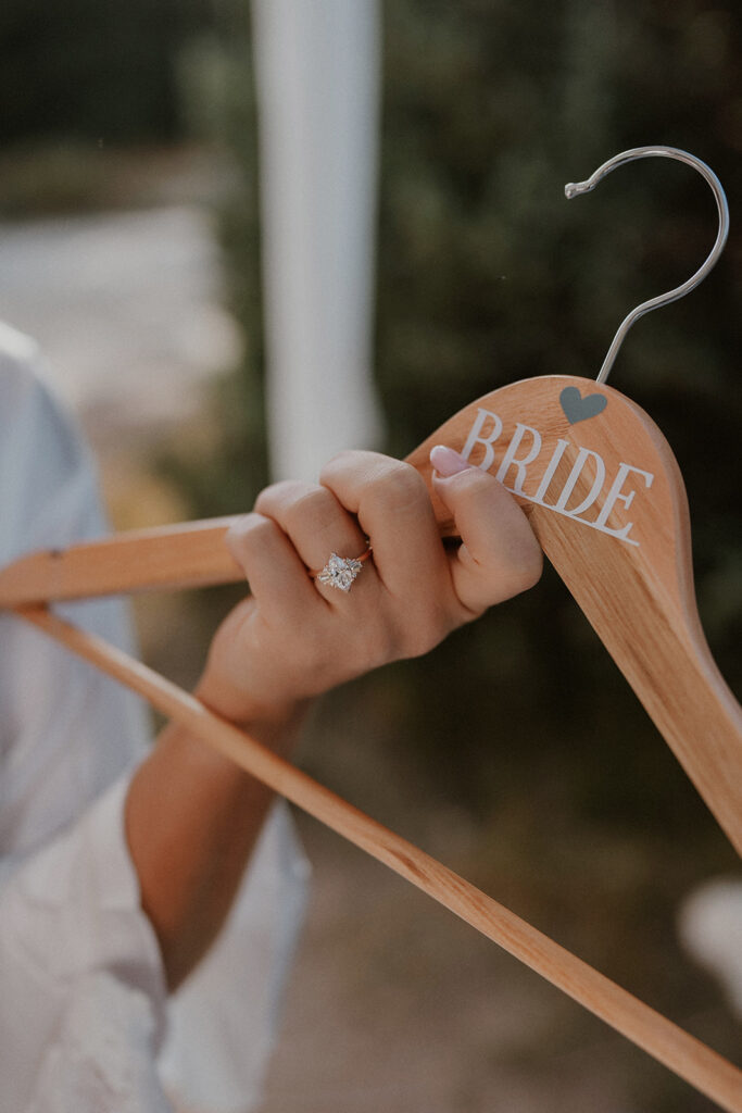 Bride holding a hanger that says bride