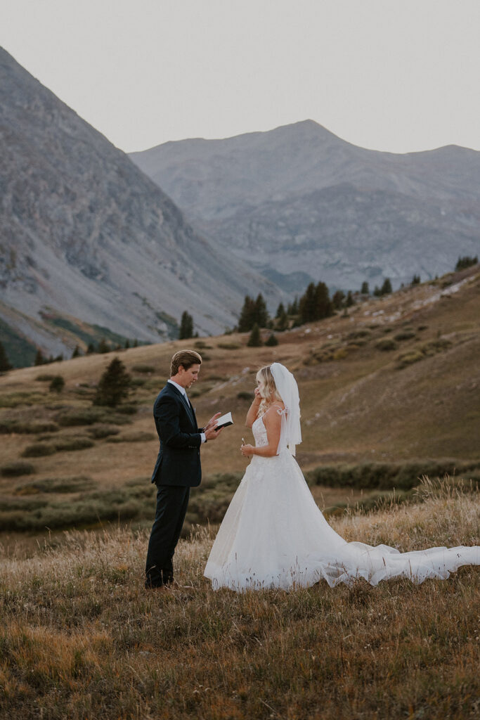 Groom reading private vows to his groom at Hoosier Pass in Breckenridge, Colorado