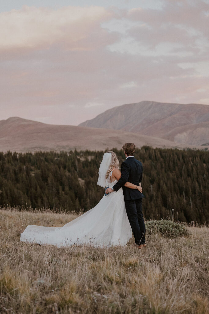 Bride and groom admiring the mountains for their intimate Breckenridge wedding portraits