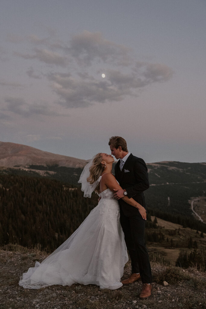 Outdoor mountain wedding portraits in Breckenridge with the moon in the background