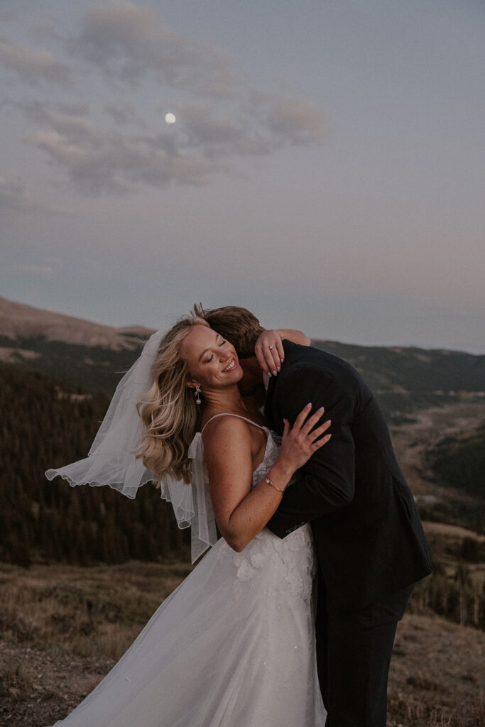 Outdoor mountain wedding portraits in Breckenridge with the moon in the background