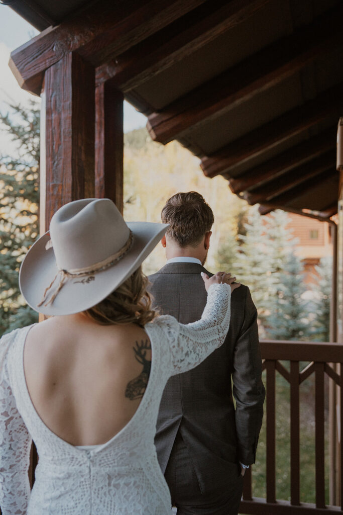 Bride tapping the groom on his shoulder during their first look