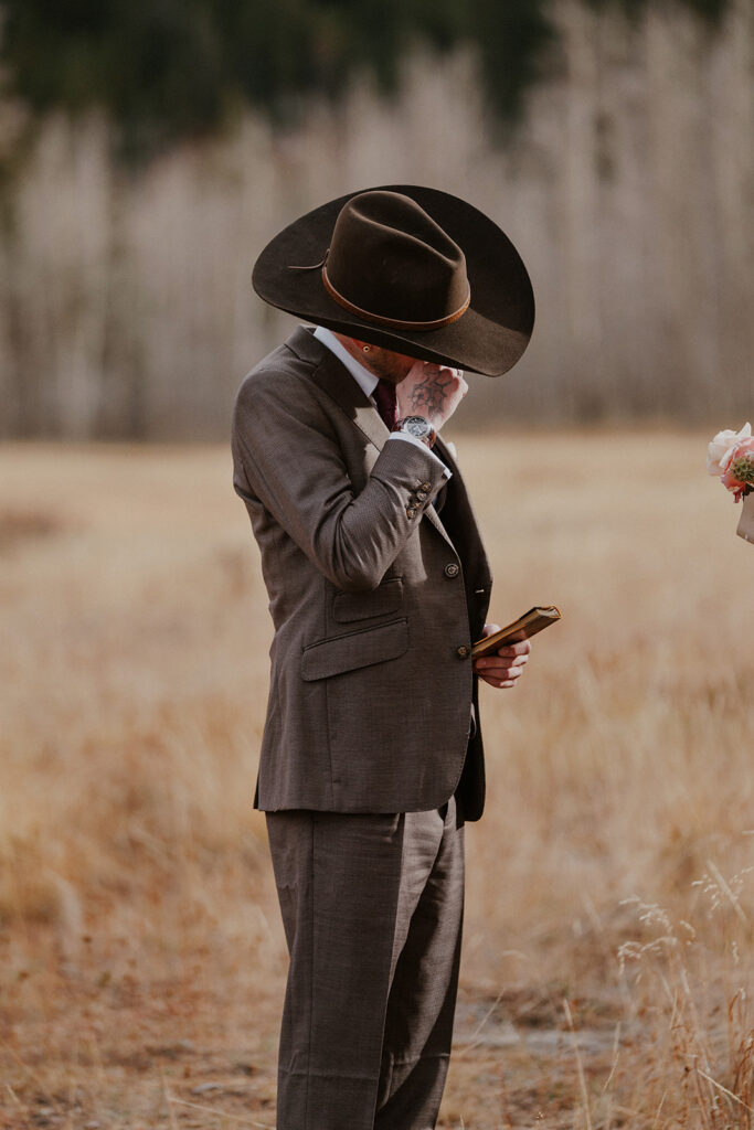 Groom getting emotional as he listens to his bride read her vows