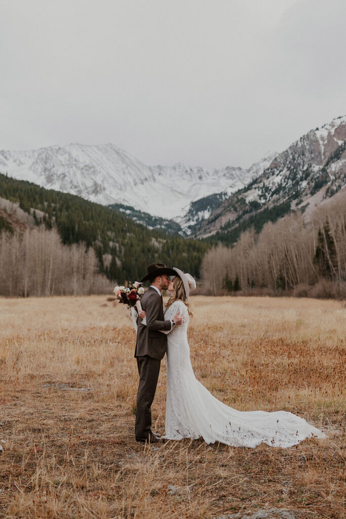 Bride and groom kissing in the Colorado mountains during their Aspen elopement