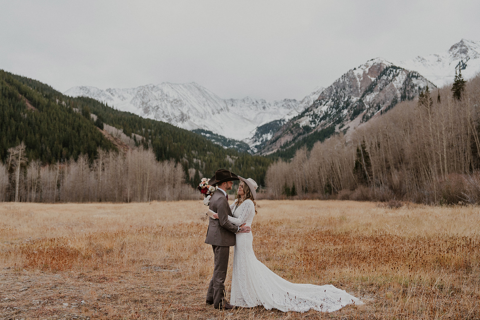 Bride and groom posing in the Aspen, Colorado mountains