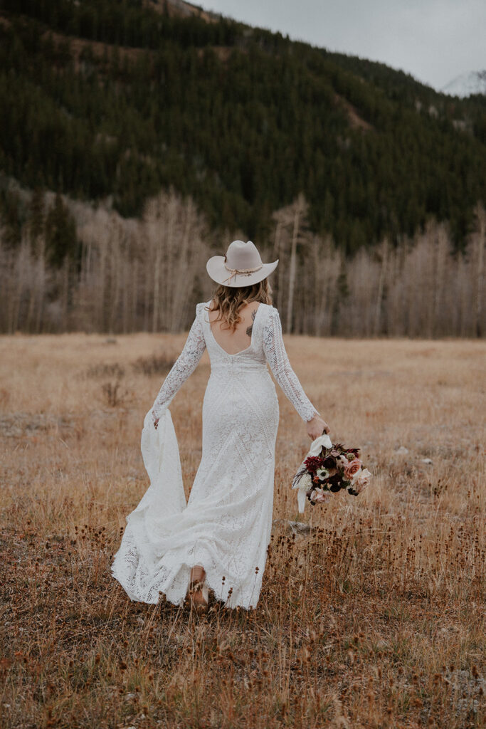 Bride posing in the Colorado mountains for her Ashcroft Ghost Town elopement in Aspen, CO