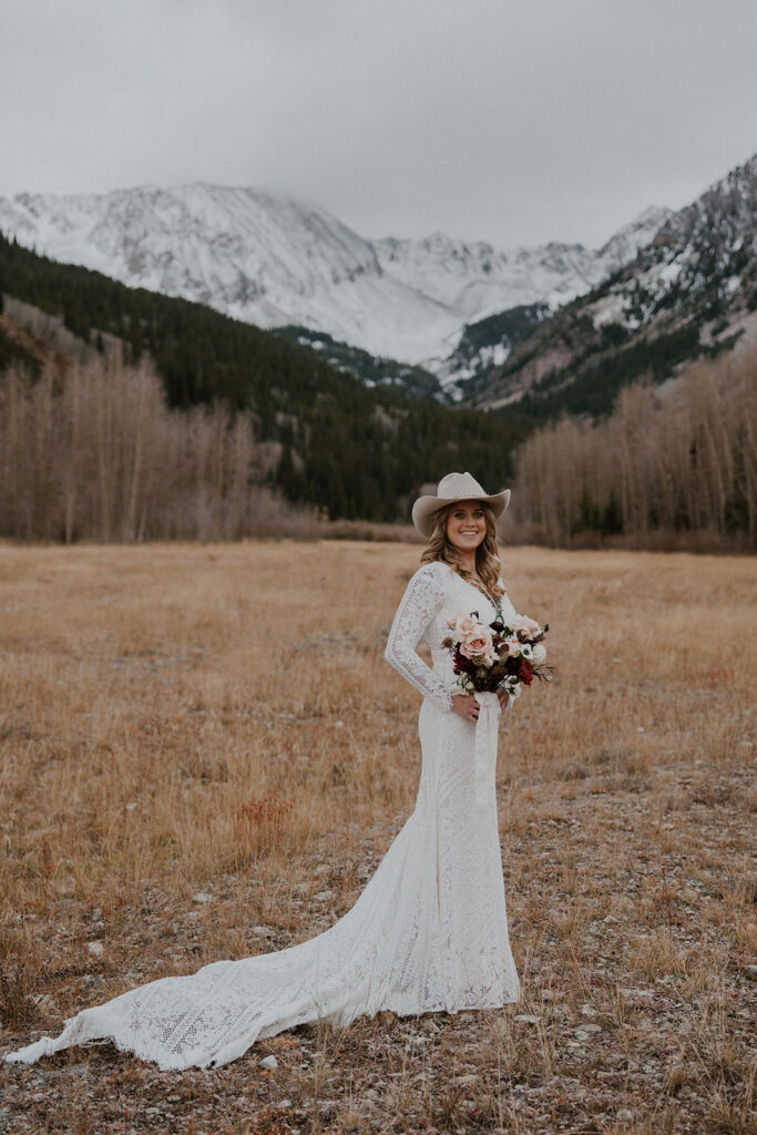 Bride posing in the Colorado mountains for her Ashcroft Ghost Town elopement in Aspen, CO