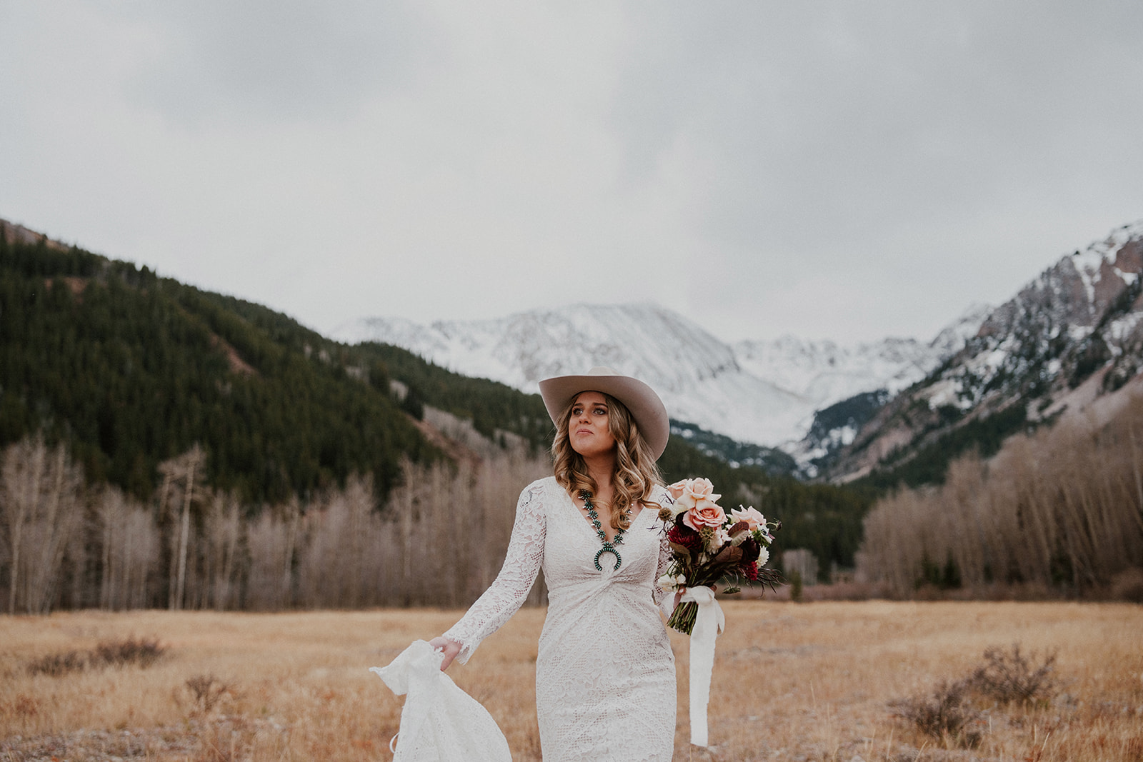 Bride posing in the Aspen, Colorado mountains during her intimate elopement