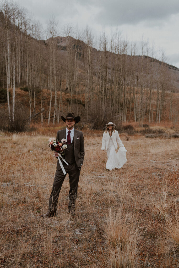 Bride and groom posing in the Colorado mountains of Aspen