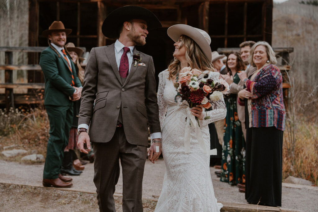 Bride and groom walking back down the aisle after their intimate Ashcroft Ghost town elopement ceremony in Aspen, Colorado