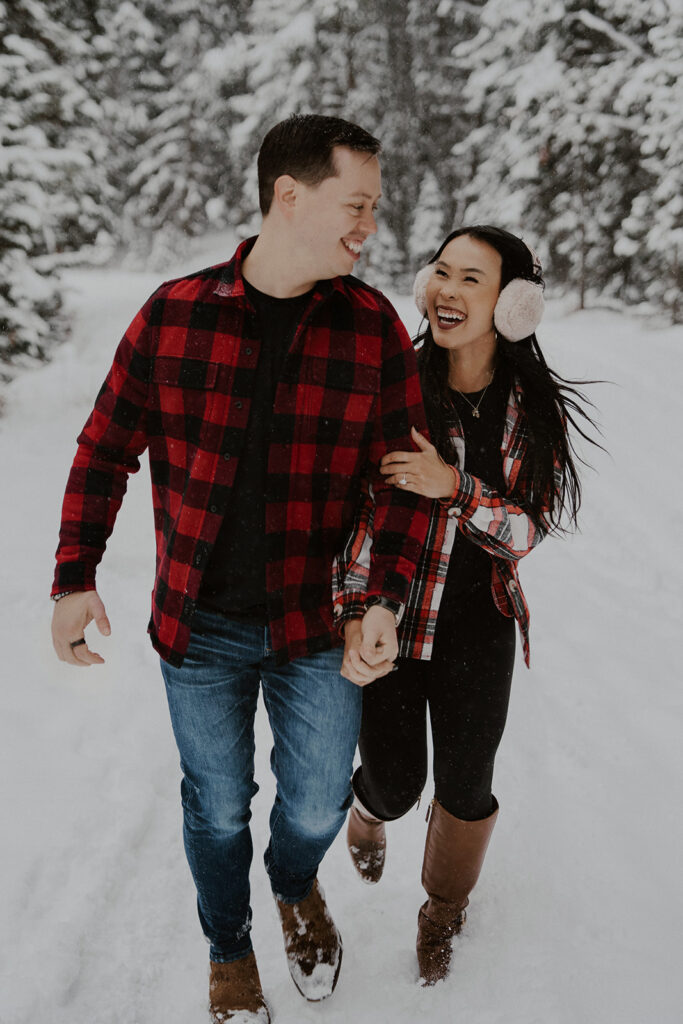 Couple wearing flannel during their snowy Colorado engagement session