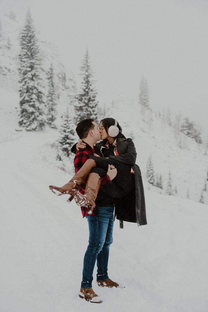 Man holding his fiancé in his arms during their Boreas Pass engagement