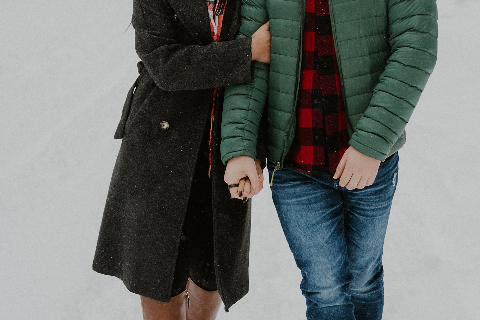 Couple wearing winter engagement outfits for their snowy Boreas Pass engagement session