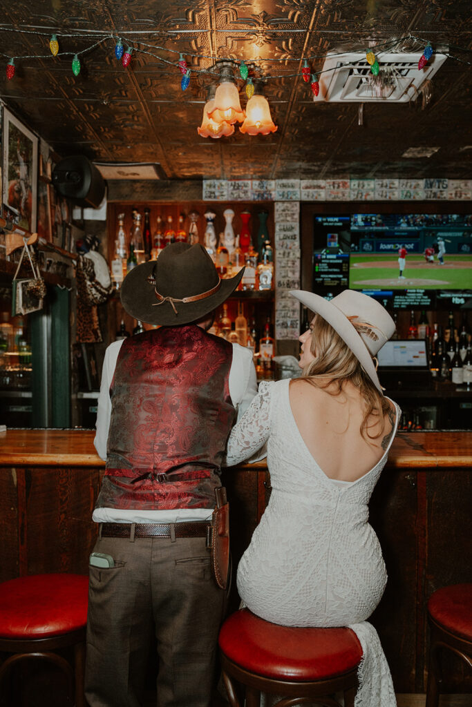 Bride and groom having drinks during their intimate reception at Woody Creek Tavern