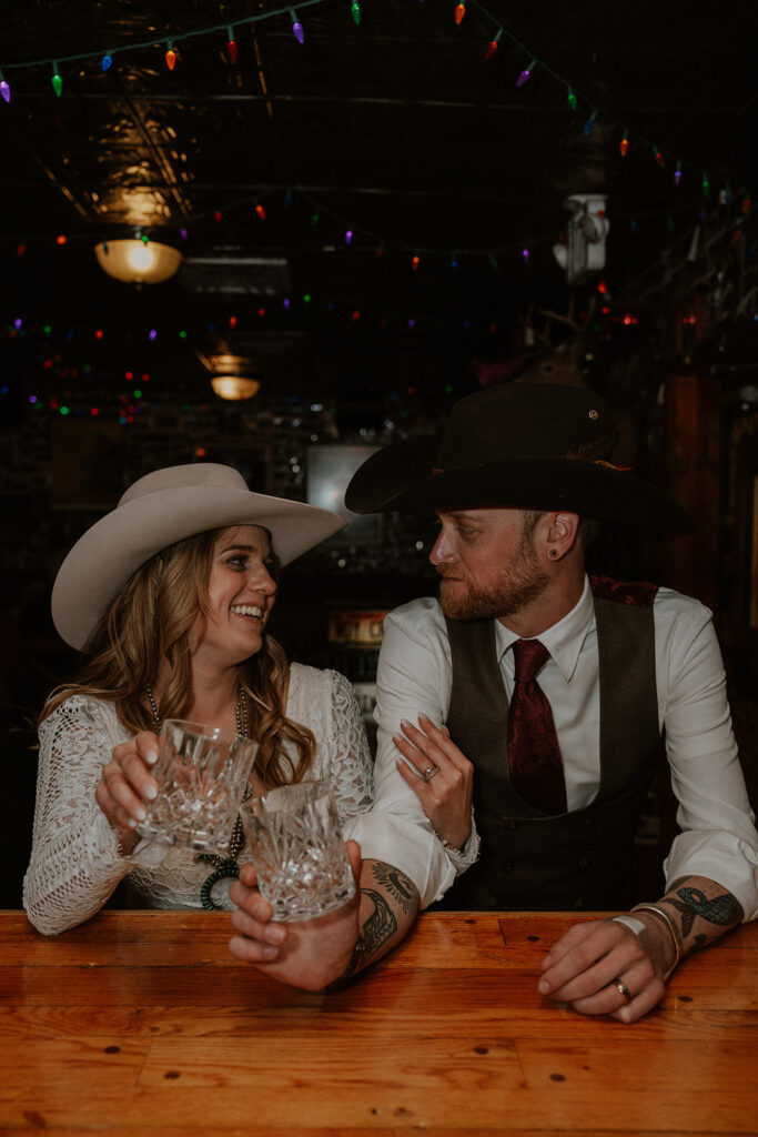 Bride and groom having drinks during their intimate reception at Woody Creek Tavern